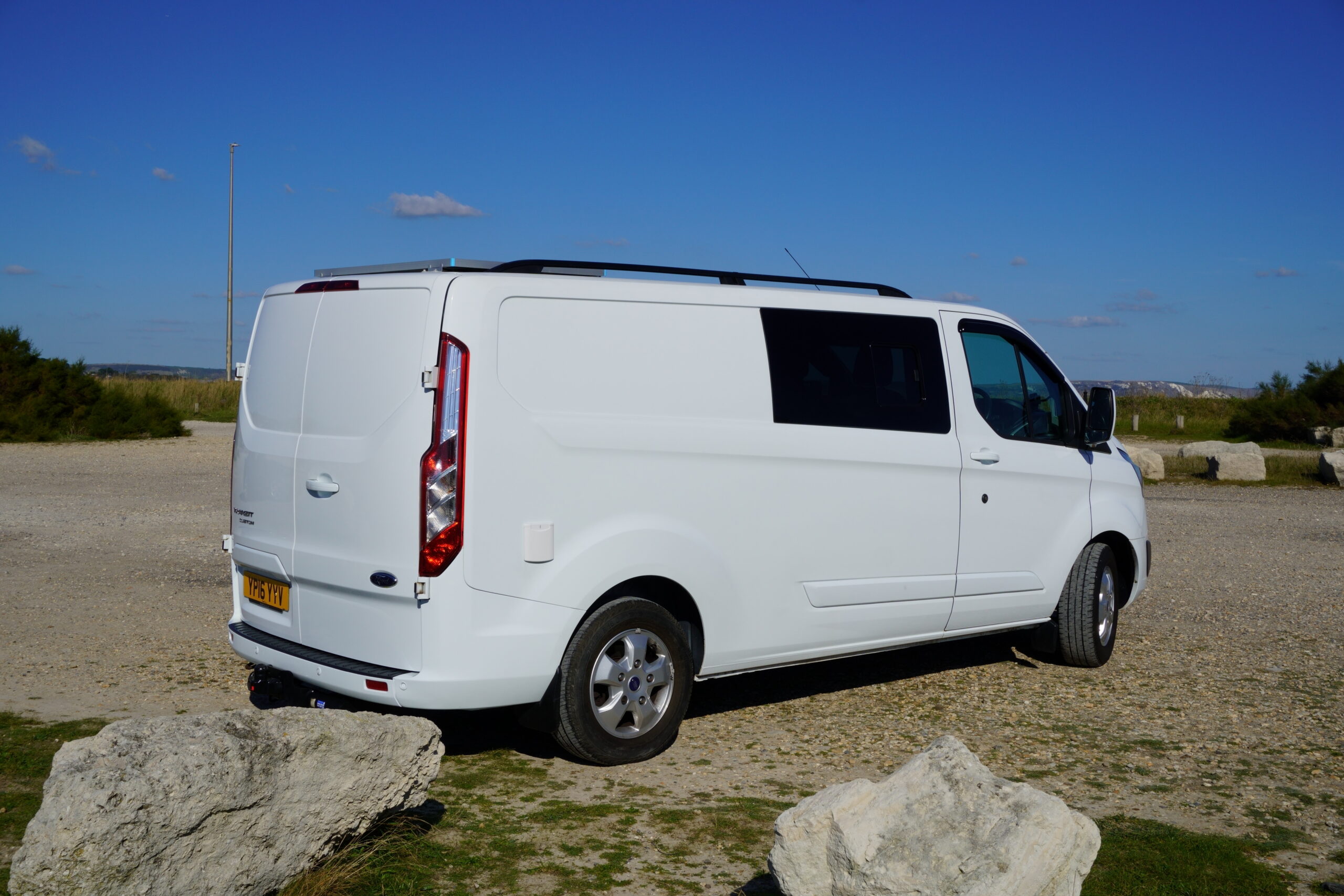 Coastal Weekender white campervan rear three-quarter exterior at the coast