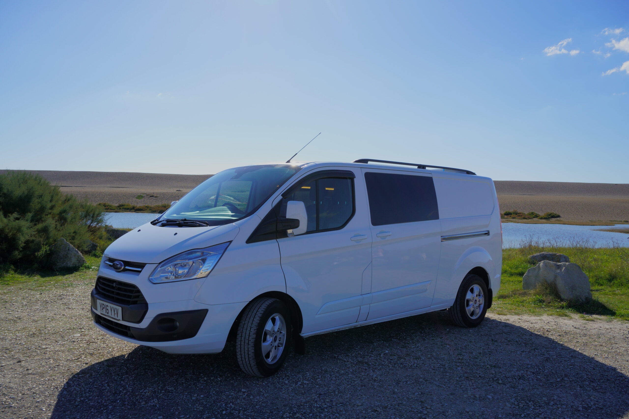 Coastal Weekender white campervan front three-quarter exterior by water